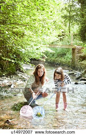 Mother and daughter with fishing net View Large Photo Image Stock Photo - Mother and daughter with fishing net. Fotosearch