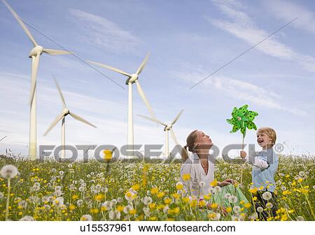 Stock Image - mother and son at wind turbine. Fotosearch