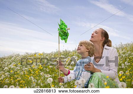 Stock Image - mother and son with green toy windmill. Fotosearch