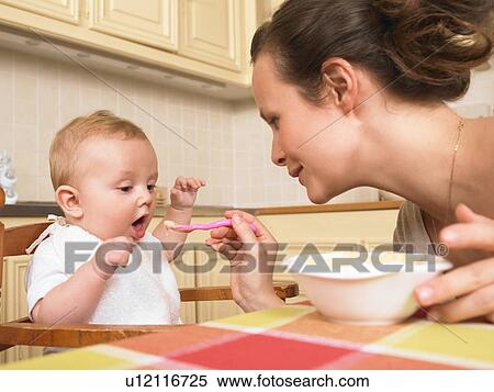 mother feeding baby View Large Photo Image Stock Photography - mother feeding baby. Fotosearch