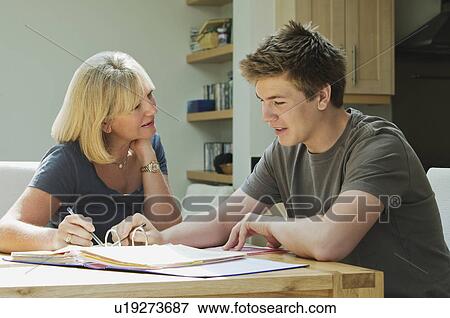 Mother helping son with homework View Large Photo Image Stock Photo - Mother helping son with homework. Fotosearch
