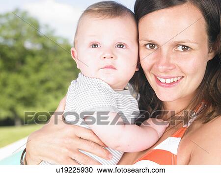 Stock Image - mother holding baby. Fotosearch
