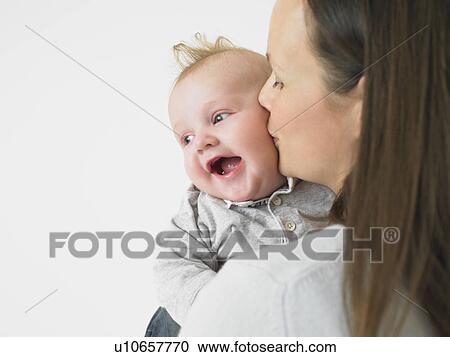 Stock Image - mother kissing baby. Fotosearch