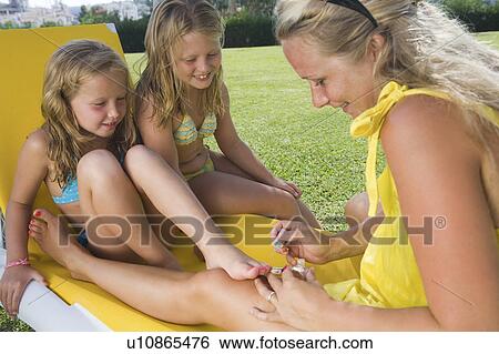 Mother painting toenails of two girls View Large Photo Image Stock Photograph - Mother painting toenails of two girls. Fotosearch