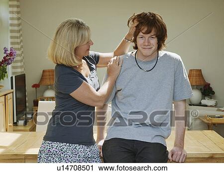 Mother stroking sons head View Large Photo Image Stock Image - Mother stroking sons head. Fotosearch