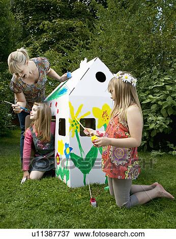Mum and girls play with wendy house View Large Photo Image Stock Photo - Mum and girls play with wendy house. Fotosearch