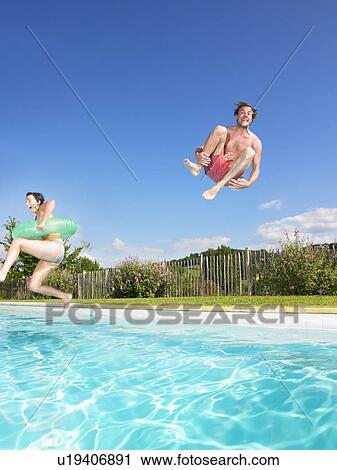 Stock Image - people jumping into pool. Fotosearch