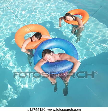 Stock Image - people sleeping in pool. Fotosearch