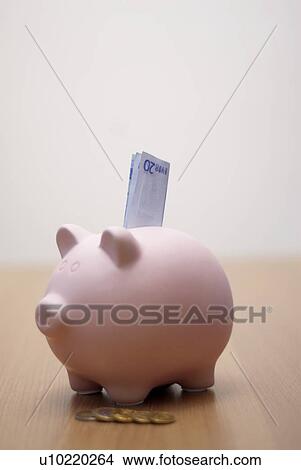 Picture - piggy bank with money in it. Fotosearch