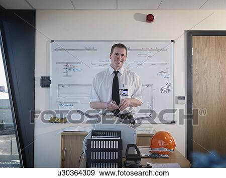Stock Photo - Port Worker In Control Tower Office. Fotosearch