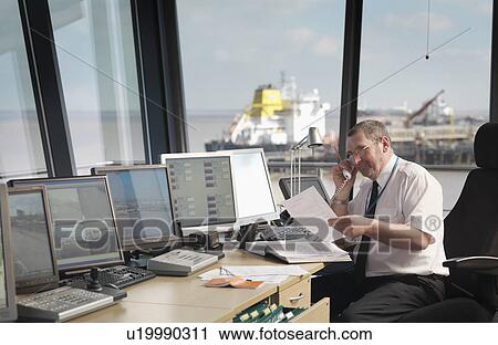 Stock Image - Port Worker In Control Tower. Fotosearch