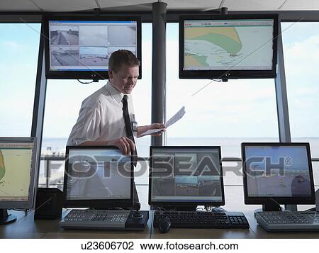Stock Image - Port Worker In Control Tower. Fotosearch