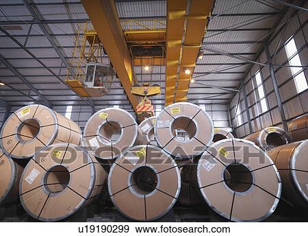 Stock Photo - Port Worker In Crane Sorting Cargo. Fotosearch