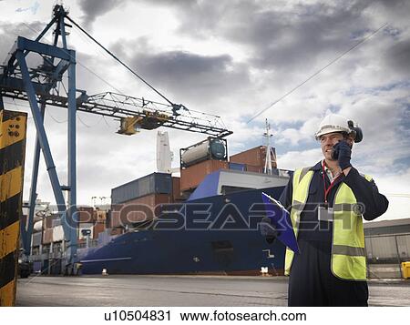 Port Worker In Front Of Loaded Ship View Large Photo Image Stock Image - Port Worker In Front Of Loaded Ship. Fotosearch