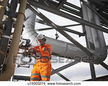Picture - Port Worker In Power Station Environment. Fotosearch