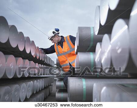Stock Image - Port Worker Inspecting Cargo. Fotosearch