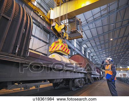Picture - Port Worker Loading Cargo On To Train. Fotosearch