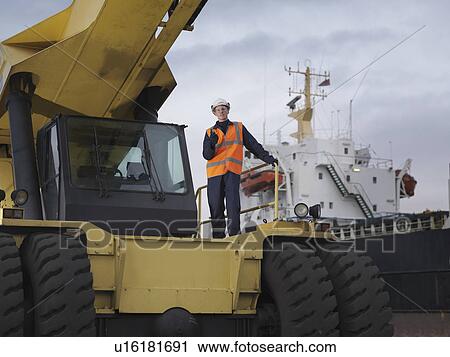 Port Worker Standing On Container Grab View Large Photo Image Stock Image - Port Worker Standing On Container Grab. Fotosearch