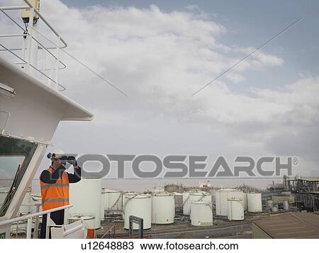 Port Worker With Binoculars On Ship View Large Photo Image Stock Image - Port Worker With Binoculars On Ship. Fotosearch
