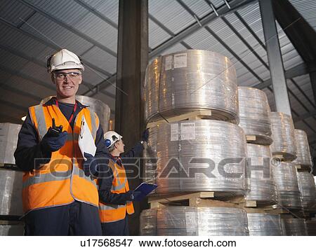 Port Worker With Clipboard & Cargo View Large Photo Image Stock Photo - Port Worker With Clipboard & Cargo. Fotosearch