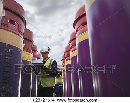 Picture - Port Worker With Clipboard & Containers. Fotosearch