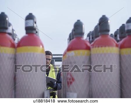 Port Worker With Gas Canisters View Large Photo Image Stock Photo - Port Worker With Gas Canisters. Fotosearch
