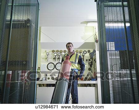 Stock Image - Port Worker With Gas Cylinder. Fotosearch