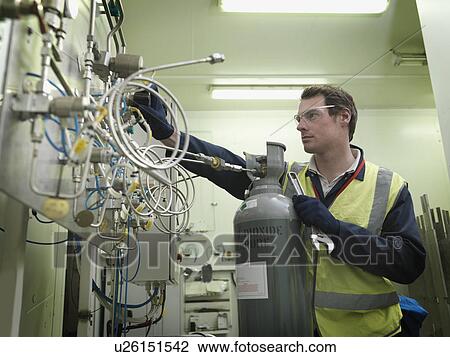 Stock Image - Port Worker With Gas Cylinder. Fotosearch