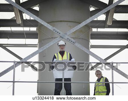 Port Worker With Plans View Large Photo Image Stock Photo - Port Worker With Plans. Fotosearch
