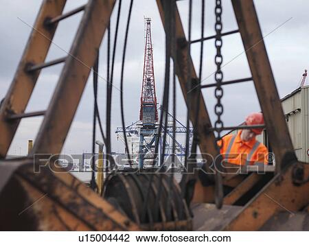 Port Worker With Pulleys And Cranes View Large Photo Image Stock Image - Port Worker With Pulleys And Cranes. Fotosearch