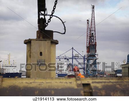Port Worker With Pulleys And Cranes View Large Photo Image Stock Image - Port Worker With Pulleys And Cranes. Fotosearch