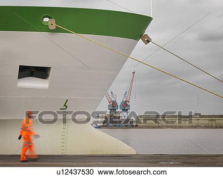 Stock Image - Port Worker With Ship At Port. Fotosearch