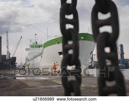 Stock Photo - Port Worker With Ship At Port. Fotosearch