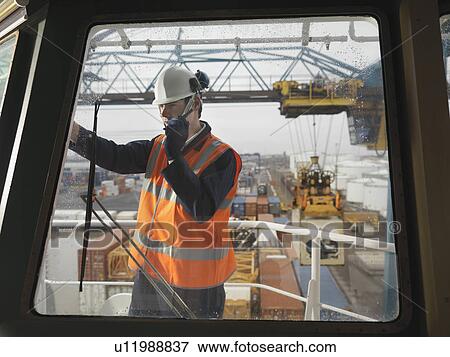 Stock Photo - Port Worker With Walkie Talkie On Ship. Fotosearch