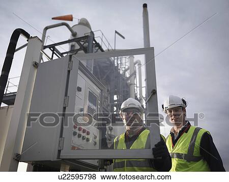 Stock Photo - Port Workers At Control Panel. Fotosearch
