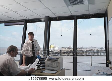 Stock Photo - Port Workers In Control Tower. Fotosearch