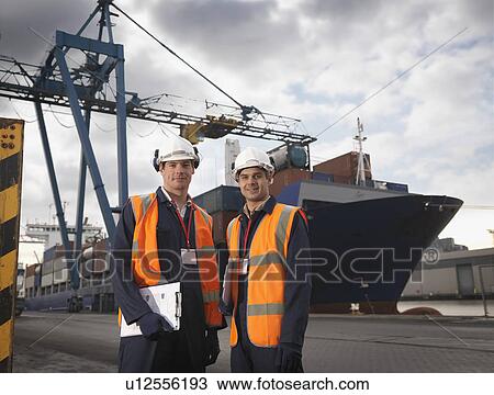 Stock Image - Port Workers In Front Of Ship. Fotosearch