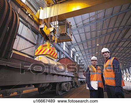 Stock Photo - Port Workers Loading Cargo On To Train. Fotosearch