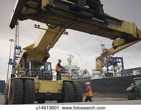 Stock Image - Port Workers With Container Grab. Fotosearch