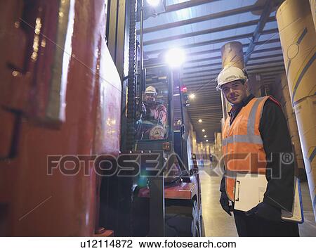 Stock Image - Port Workers With Fork Lift Truck. Fotosearch