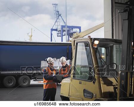 Stock Photo - Port Workers With Forklift Truck. Fotosearch