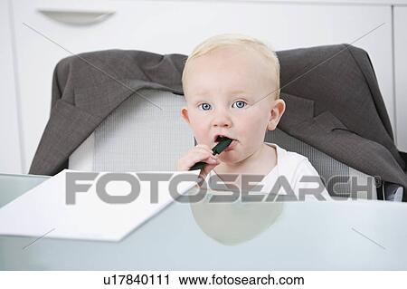 Stock Image - Portrait of a baby in an office chair. Fotosearch