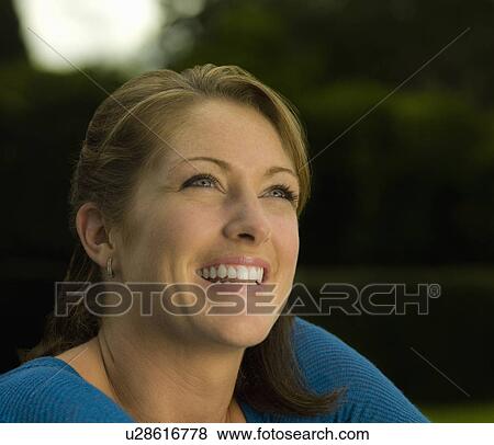 Portrait of a female smiling off camera View Large Photo Image Stock Photo - Portrait of a female smiling off camera. Fotosearch