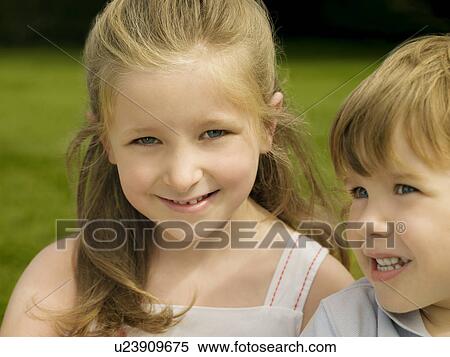 Stock Photography - Portrait of a girl with her brother. Fotosearch