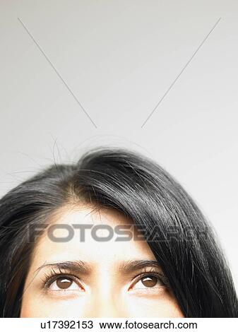Stock Image - Portrait of a woman looking up. Fotosearch