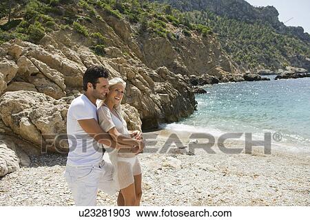 Portrait of a young beach couple View Large Photo Image Stock Image - Portrait of a young beach couple. Fotosearch
