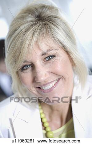 Stock Image - Portrait of an older smiling Businesswom. Fotosearch