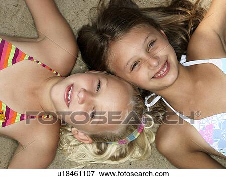 Stock Photo - Portrait of girls on a beach. Fotosearch