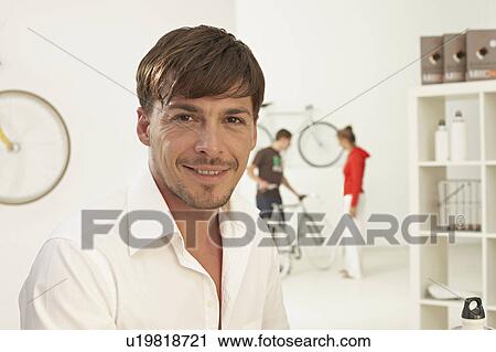 Stock Image - portrait of man in bikestore. Fotosearch