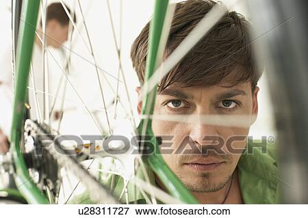 Stock Photo - portrait of man in bikestore. Fotosearch